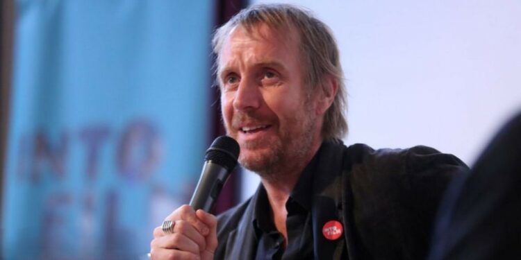 Rhys Ifans with a mic