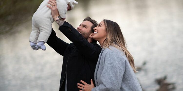 Dom Lever with his wife Jessica Shears holding their baby Dom Lever with his wife Jessica Shears holding their baby