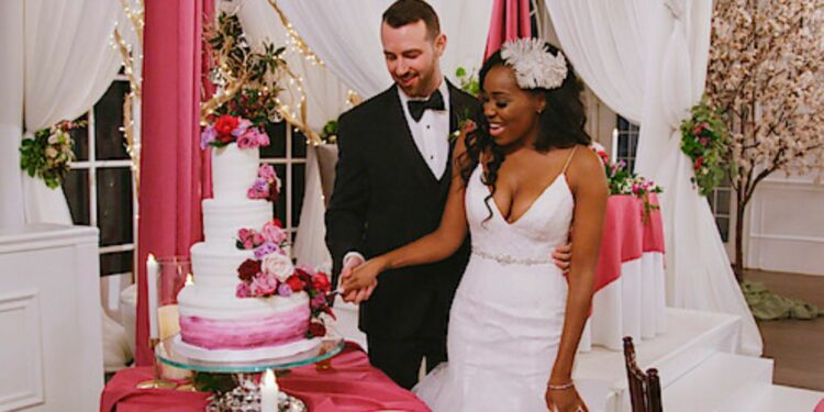 Cameron Hamilton and Lauren Speed Hamilton cutting the cake