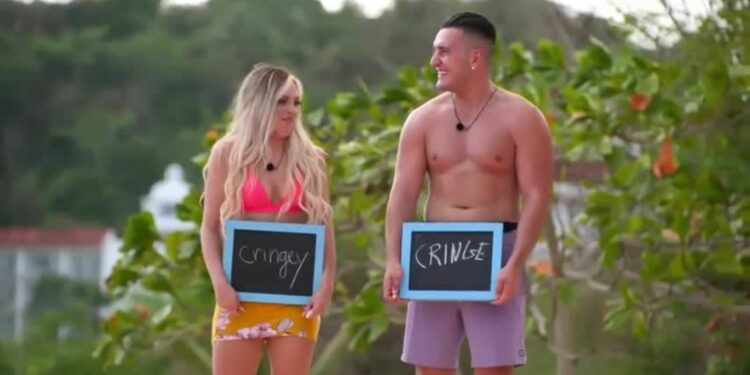 Joey Sasso and Kariselle Snow holding sign boards