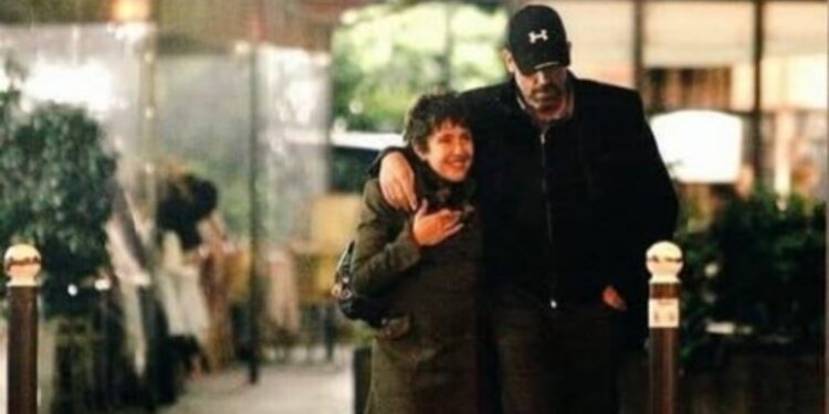 Hugh Laurie and Jo Green walking in streets