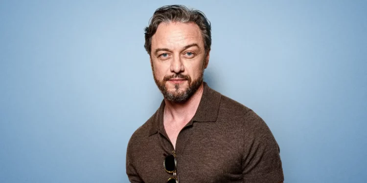 James McAvoy posing in front of a sky blue background James McAvoy posing in front of a sky blue background