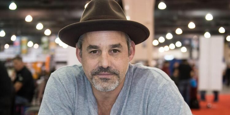 Nicholas Brendon wearing a hat and grey shirt Nicholas Brendon wearing a hat and grey shirt