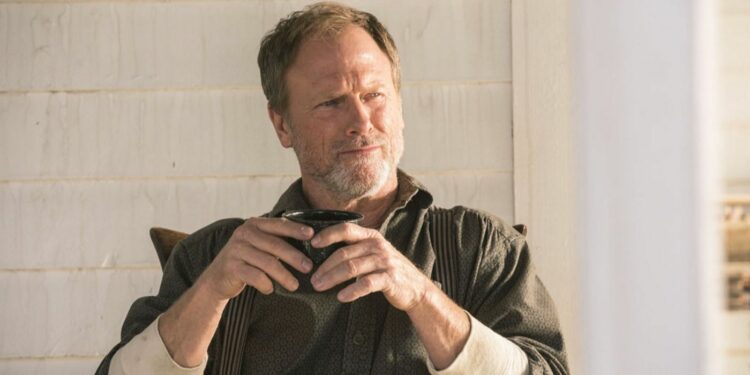 Louis Herthum holding a cup