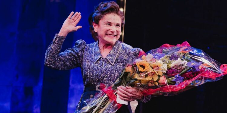 Tovah Feldshuh holding a flower bookey