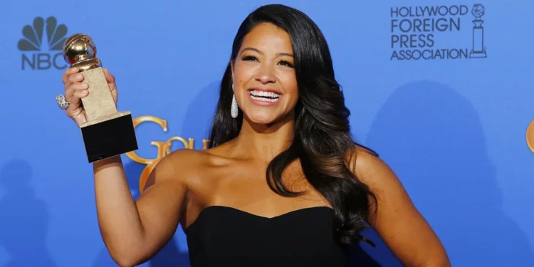 Gina Rodriguez holding her Golden Globe Award Gina Rodriguez holding her Golden Globe Award